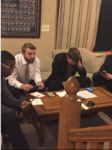  Pike Health and Safety Director Alex Schmidt (middle) and chapter President Tyler Kobussen (right) fill out bid cards for their new members