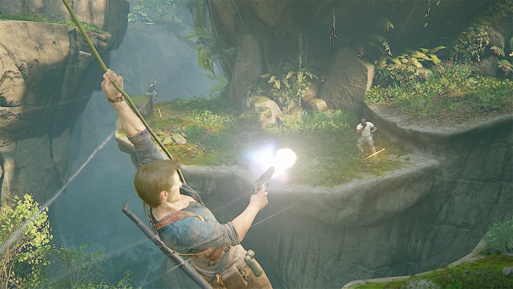 Nathan Drakes swing across a chasm using his grappling hook while firing his gun at enemies on the other side. 