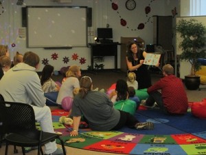 Librarian Diana Shull reads Fiesta Babies book to infant and toddler group