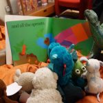 stuffed animals reading a book