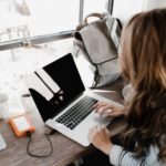 Close-up Photography of Woman Sitting Beside Table While Using Macbook.  Pexels photo by Andrew Neel