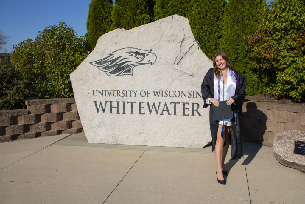 Student in front of the Warhawk Monument Rock