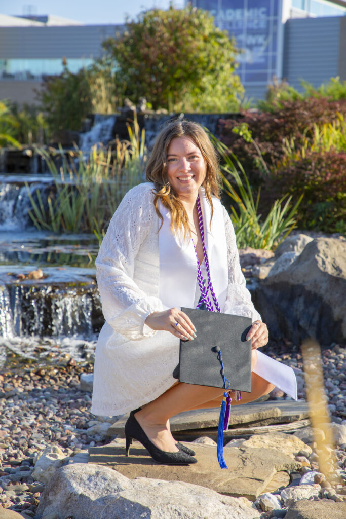 Student in front of the Minneiska Springs Fountain