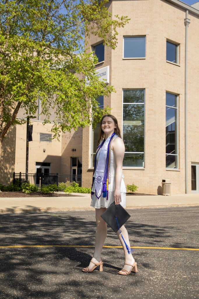 Student in front of the Center of the Arts